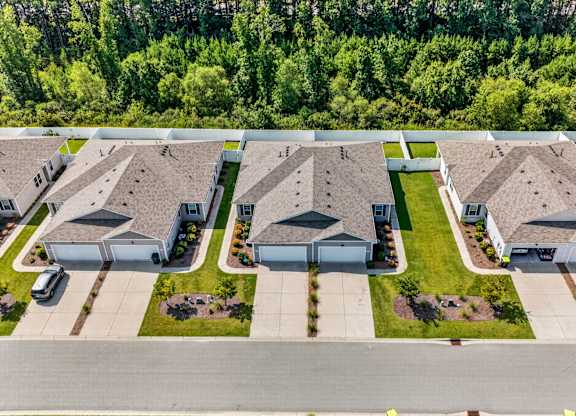 A bird's eye view of a residential area with houses and cars.