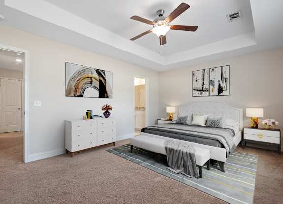 Omnia at Richmond Hill Townhomes in Georgia photo of a spacious bedroom with a bed and a ceiling fan.
