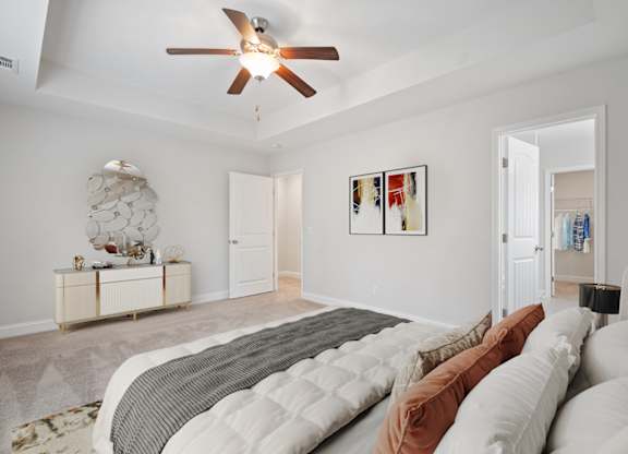 Harris Trail Luxury Townhomes for rent Richmond Hill, GA photo of a bedroom with a large bed and a ceiling fan