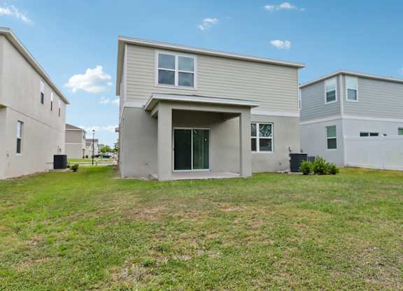 A house with a grey roof and a white garage door.