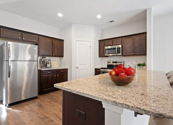Harris Trail Luxury Townhomes for rent Richmond Hill, GA photo of a kitchen with stainless steel appliances and a granite counter top