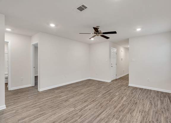 A room with a ceiling fan and lighting fixtures.