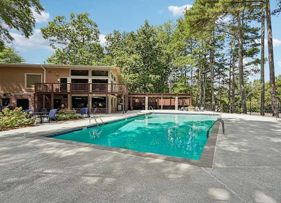 A large swimming pool in front of a resort.