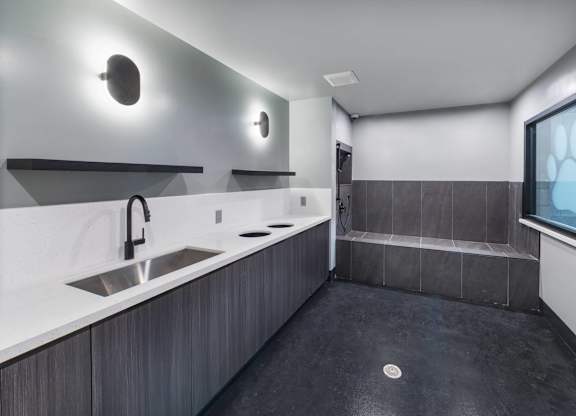 A modern bathroom with a sink and a window.