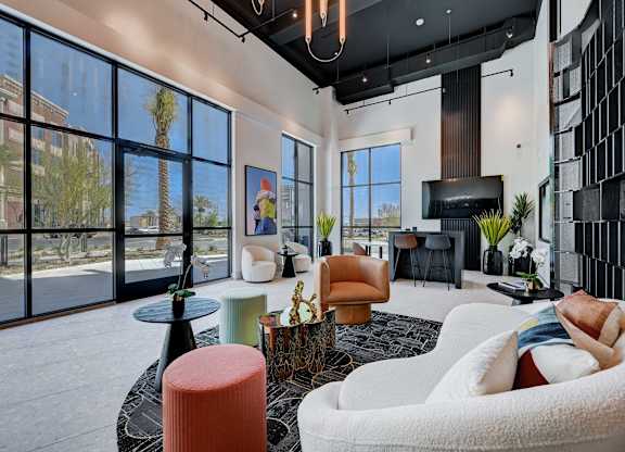 A modern living room with a large window overlooking a street.