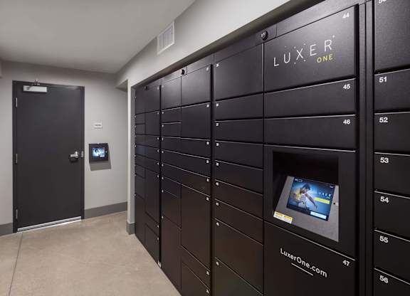 A row of black lockers with the word LUXER ONE on the top.