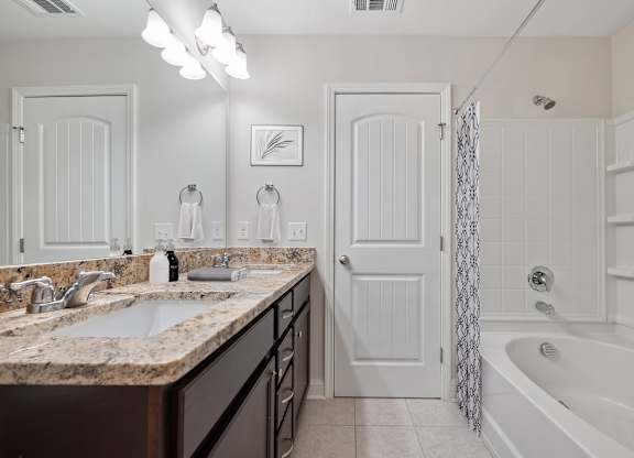 Harris Trail Luxury Townhomes for rent Richmond Hill, GA photo of a bathroom with a sink and a shower and a bath tub