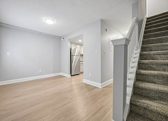 A room with a staircase on the right side.