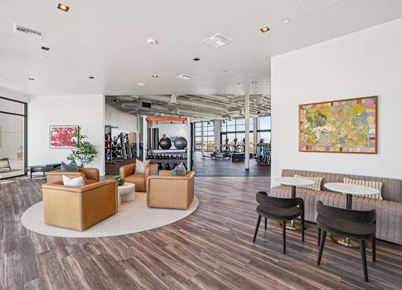 A modern living room with a large painting on the wall.