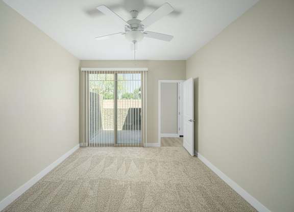 A room with a carpeted floor and a ceiling fan.