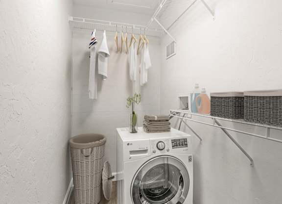 Addison Lane Apartment homes in Gainesville Florida photo of a small laundry room with a washing machine and dryer