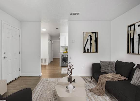 Pet-friendly living room with couch and coffee table at Addison Lane Apartment Homes in Gainesville, FL