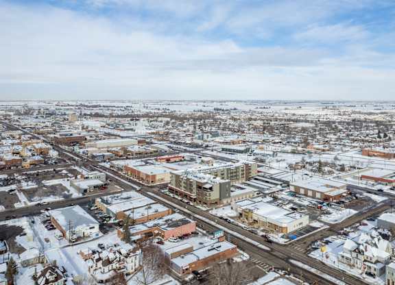 A small town with buildings and roads covered in snow.