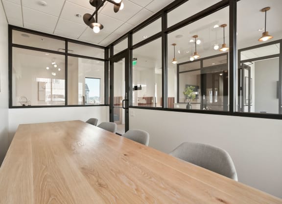 a conference room with large windows and a wooden table