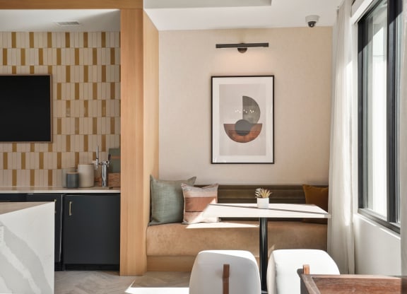 a living room with a couch and a table in front of a window