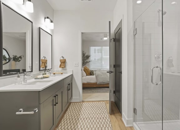 a bathroom with a shower and a sink and a mirror