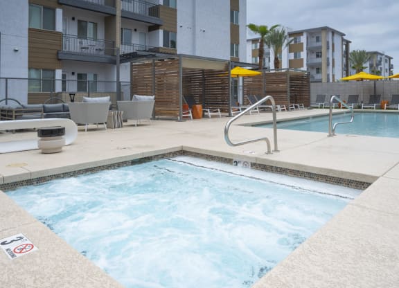 Scottsdale, AZ, Apartments - Lucent Scottsdale - Pool with Hot Tub, Poolside Seating, Lounge, and Cabanas.