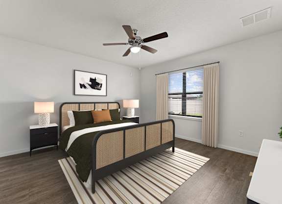 A bedroom with a bed, nightstand, and a ceiling fan.