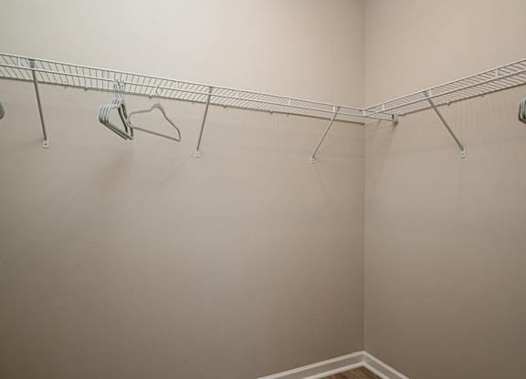 a walk in closet in a bedroom