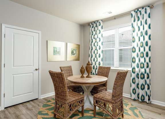 a dining room with a table and four chairs