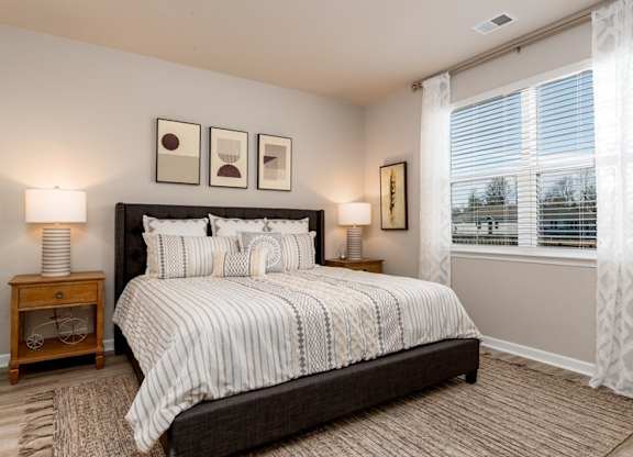 a bedroom with a large bed and a large window