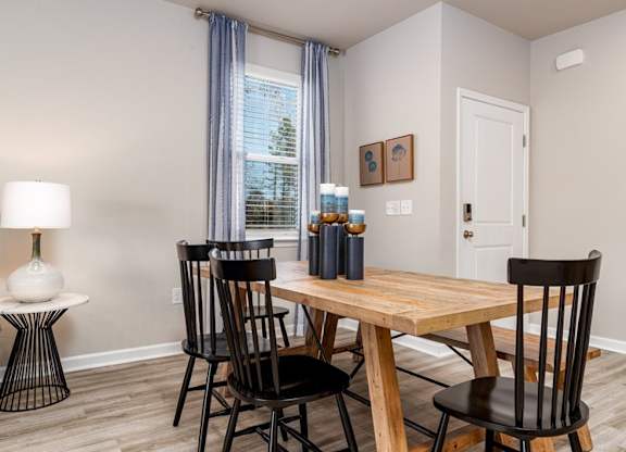 a dining room with a table and chairs