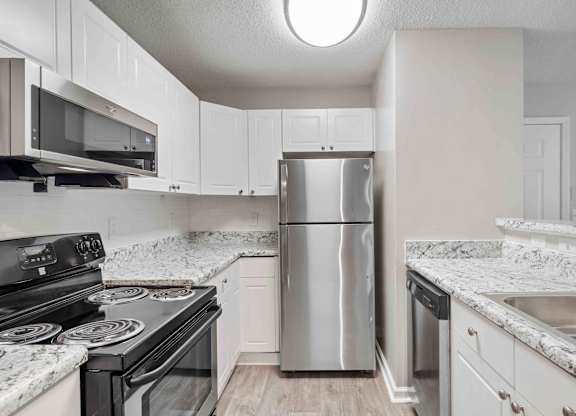 Kitchen with stainless steel appliances at Ashford at Spring Lake in Atlanta, Georgia
