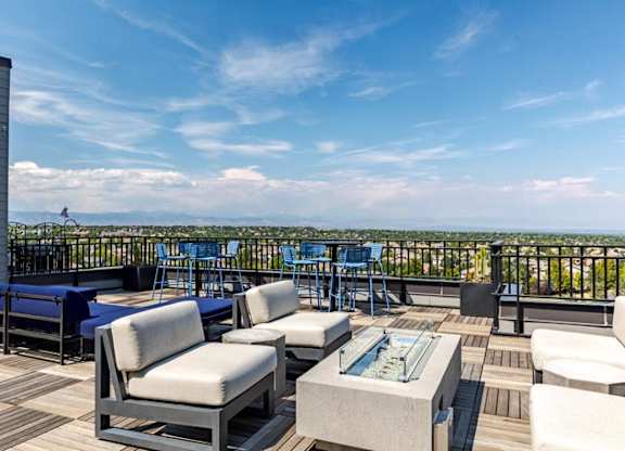 a large deck with furniture and a view of the city