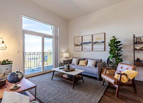 a living room with a couch and a sliding glass door