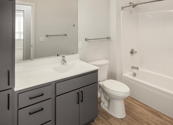 A bathroom with a white toilet and a white sink.