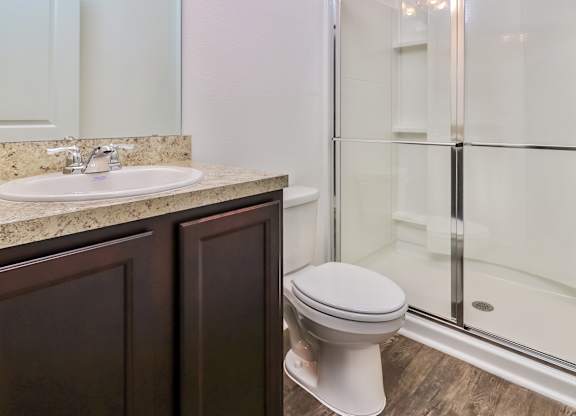 A white toilet sits next to a sink in a bathroom.