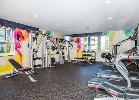 Pet-Friendly Luxury Apartments in Vancouver, WA - Autumn Grove - Fitness Center with Treadmills, Free Weights, Strength Training Equipment, Workout Benches, and Windows.