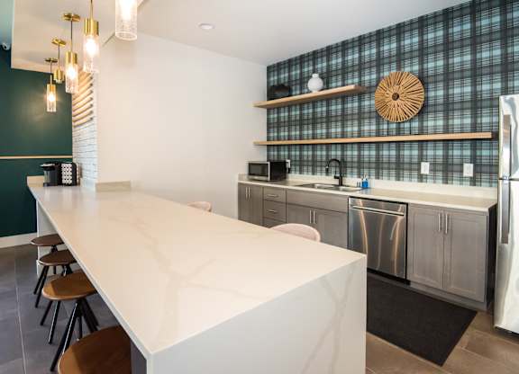 a kitchen with a white counter top and stainless steel appliances