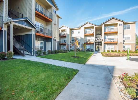 Luxury Apartments in Vancouver, WA, with In-Unit Washer and Dryer - Autumn Grove Apartments - Community Exterior with Open Walkways, and Multi-Story Residential Buildings.