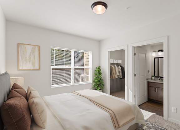 A bedroom with a bed, a mirror, and a plant.