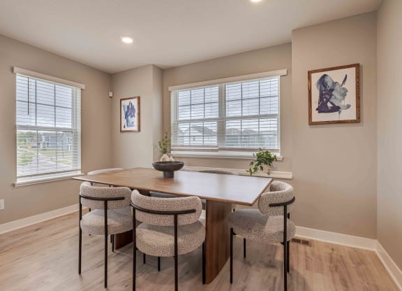 a dining room with a table and chairs