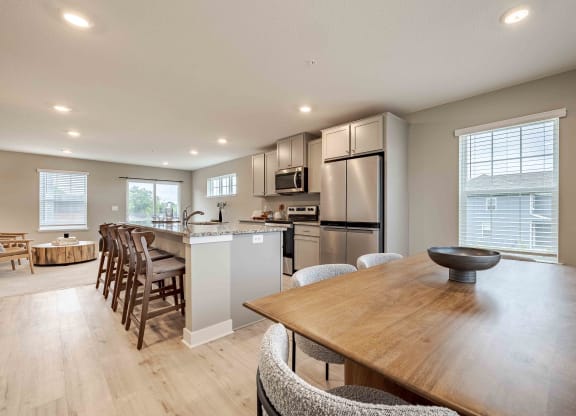a kitchen and dining room with a table and chairs