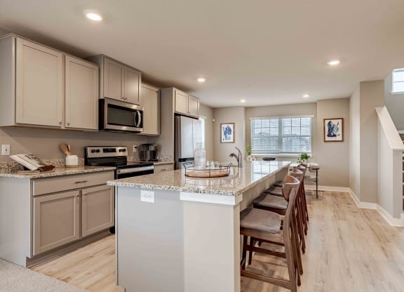 a kitchen with an island and a table with chairs