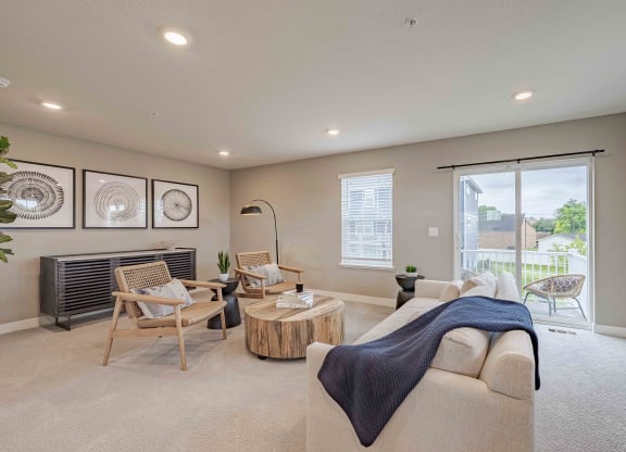 a living room with a couch and chairs and a television