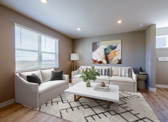 a living room with white couches and a coffee table