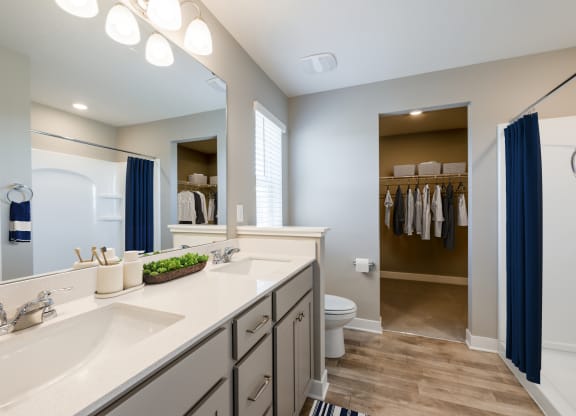 a bathroom with a large mirror and a sink and a toilet