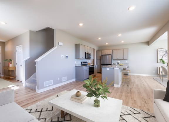 a living room and kitchen with a couch and a table