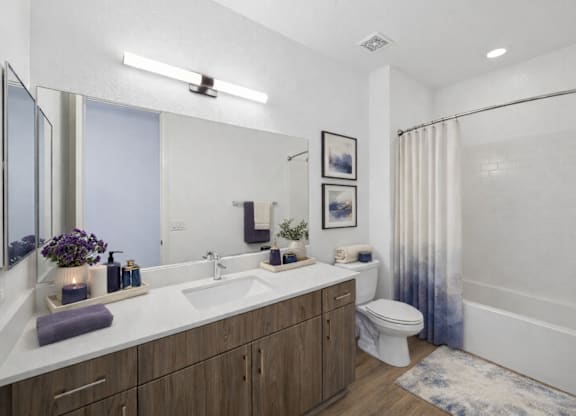 A bathroom with a white sink and a white toilet.