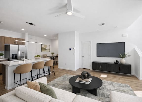 A modern living room with a bar area and a television.