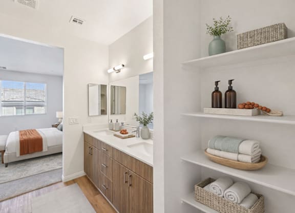 A bathroom with a white vanity and a mirror above it.