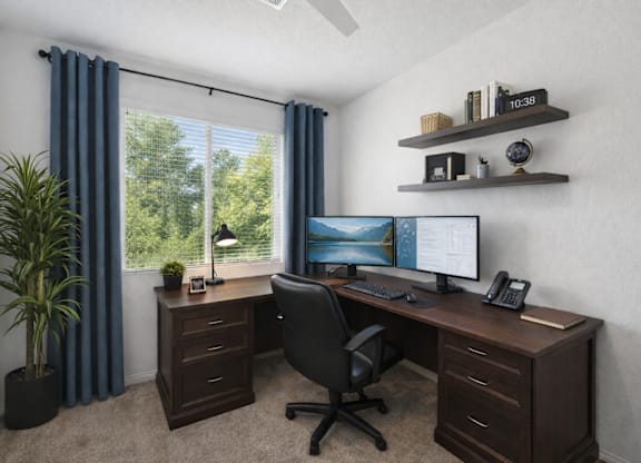 A home office with a desk, chair, and computer.