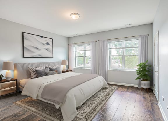 a bedroom with a bed and two windows