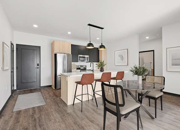 A modern kitchen with a dining table and chairs.