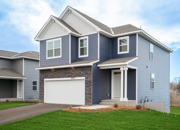 a blue house with a white garage door