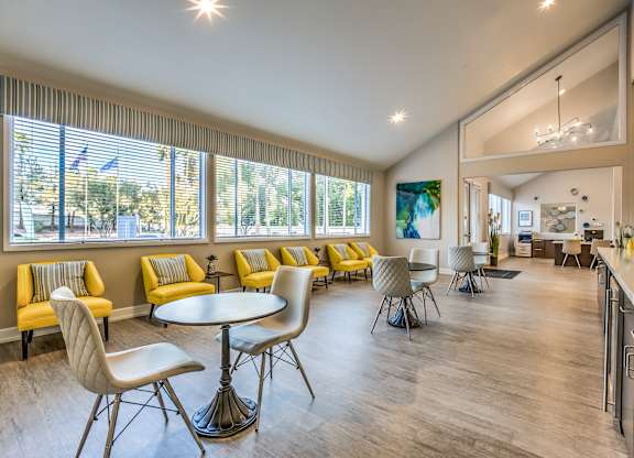 A sunny day is reflected in the windows of this spacious room.